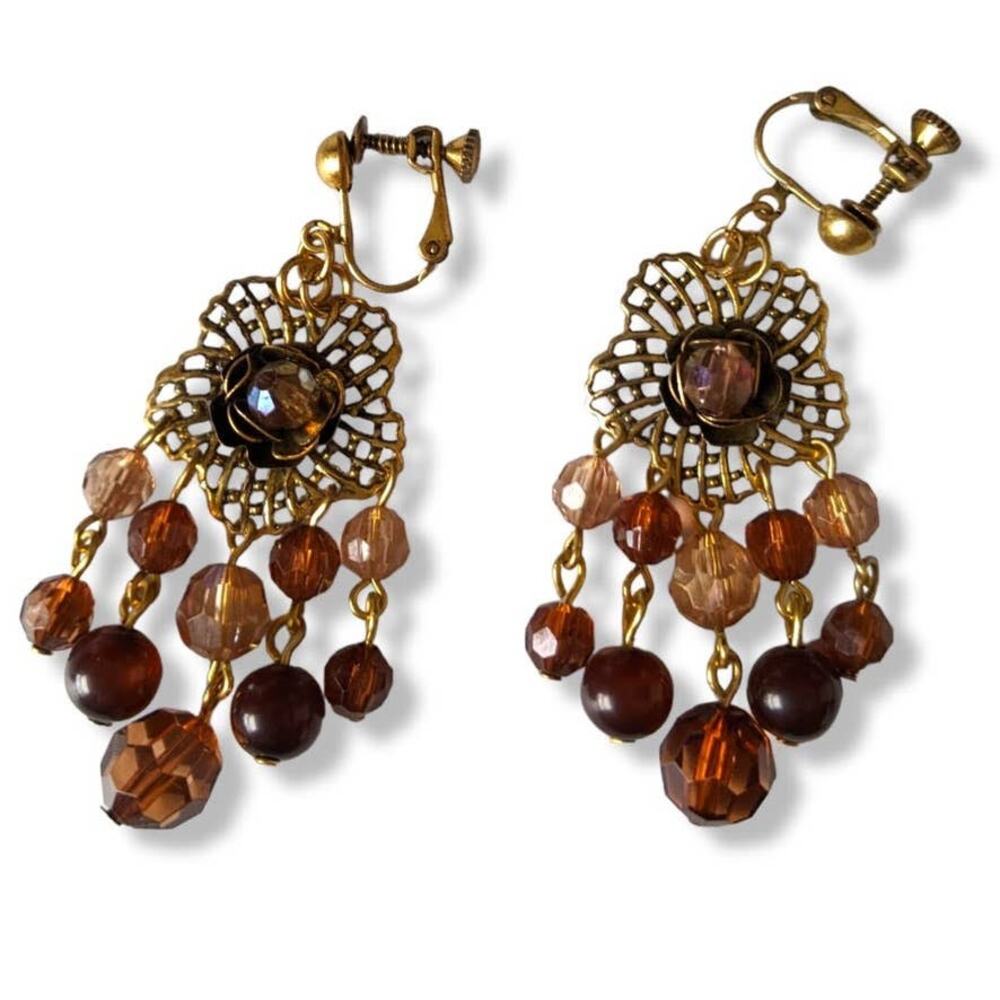Darling ornate clip on earrings with beaded accents in amber/garnet tones